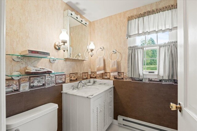 bathroom with vanity, a baseboard radiator, and toilet