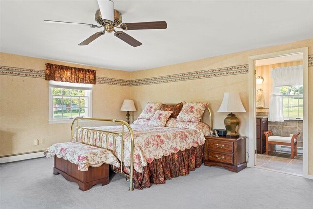 bedroom with ceiling fan, light colored carpet, and a baseboard radiator