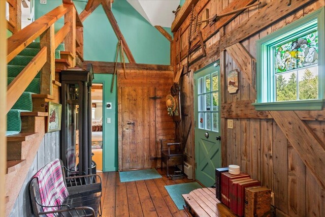 interior space featuring wooden walls, dark hardwood / wood-style flooring, and a wealth of natural light