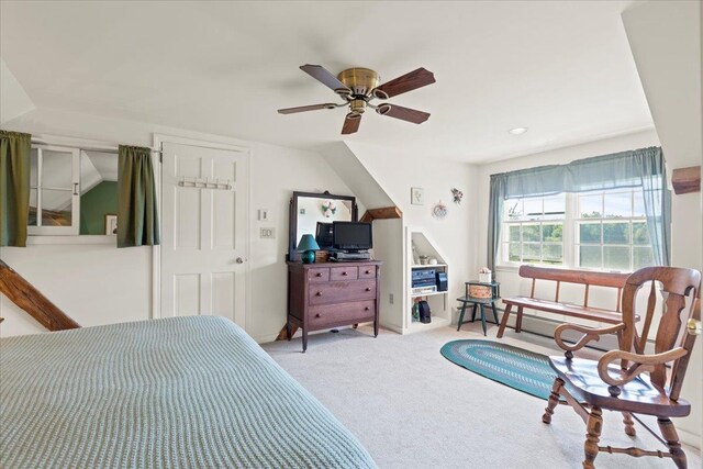 bedroom featuring lofted ceiling, ceiling fan, and light colored carpet