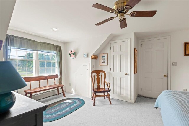 living area featuring ceiling fan and light colored carpet