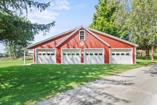 view of front of home featuring a garage and a front lawn