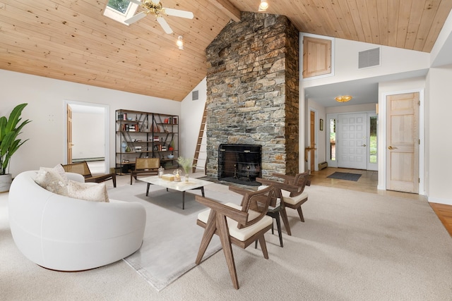 carpeted living room featuring plenty of natural light, high vaulted ceiling, a skylight, and beamed ceiling