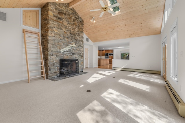 unfurnished living room featuring light carpet, a skylight, a baseboard radiator, and high vaulted ceiling