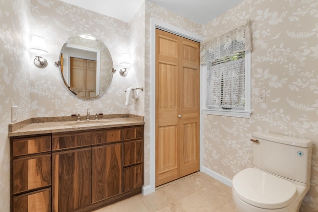 bathroom featuring tile patterned floors, vanity, and toilet