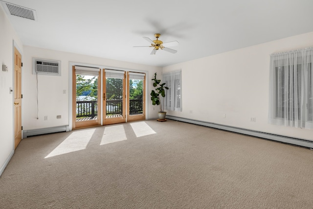 carpeted empty room with ceiling fan, a wall mounted air conditioner, and a baseboard heating unit