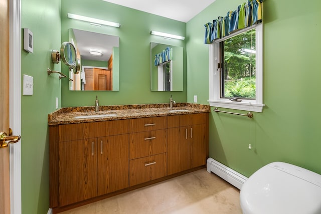 bathroom featuring vanity, baseboard heating, and toilet