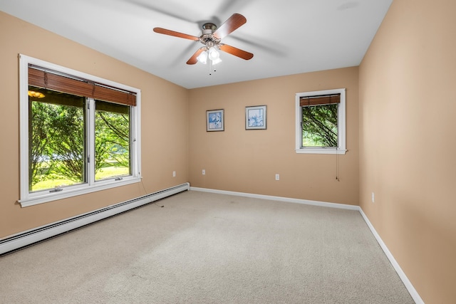 carpeted empty room with ceiling fan and a baseboard radiator