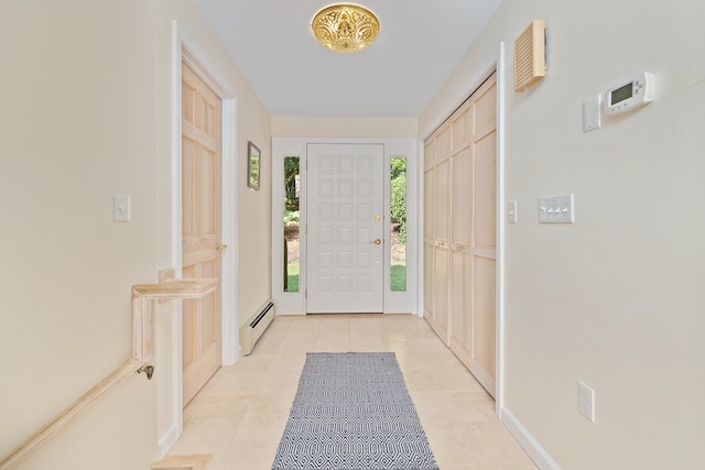 entryway with a baseboard heating unit and light tile patterned floors