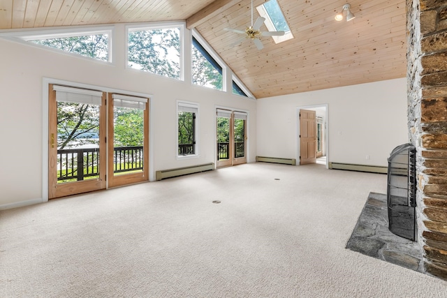 unfurnished living room with a skylight, baseboard heating, carpet flooring, and high vaulted ceiling