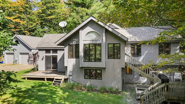 rear view of property featuring a garage and a yard