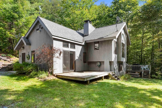 back of property featuring a yard and a deck