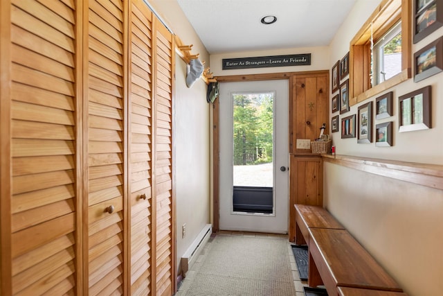 doorway with baseboard heating and tile patterned floors