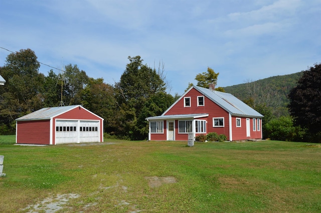 view of front of home with an outbuilding, a garage, and a front yard