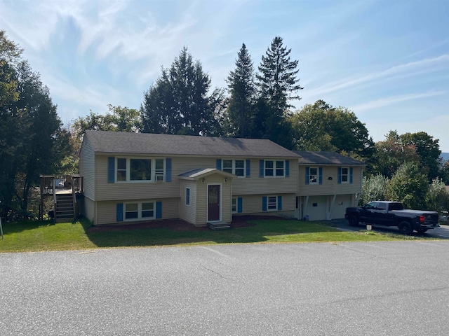 split foyer home with a front yard and a deck