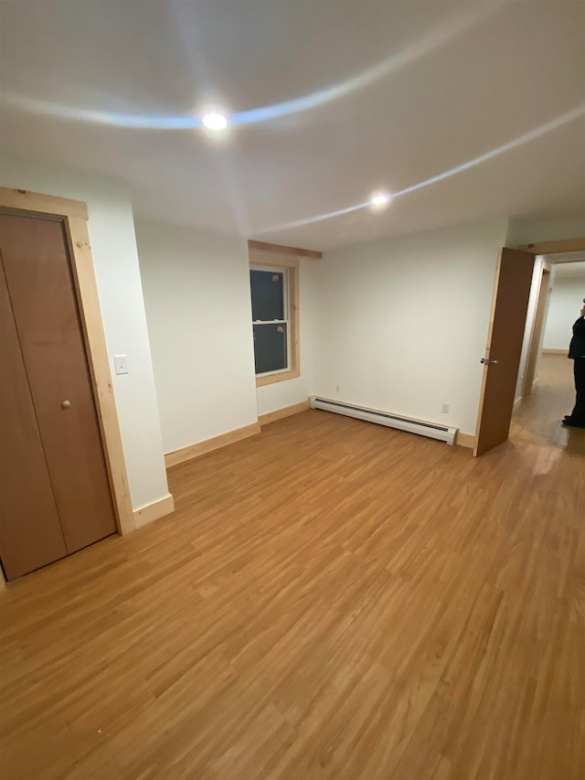 empty room featuring light hardwood / wood-style flooring and baseboard heating