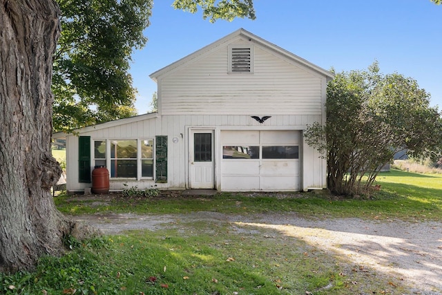 view of side of property with a lawn and a garage