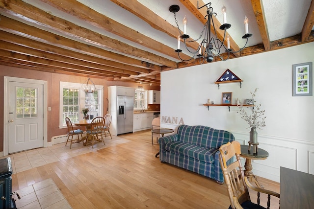 living room with light wood-type flooring, beam ceiling, an inviting chandelier, and sink