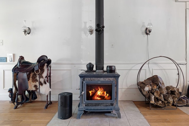 details featuring a wood stove and wood-type flooring