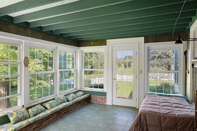 sunroom featuring beam ceiling