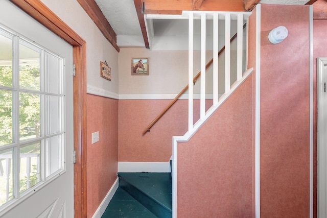 stairway with beam ceiling