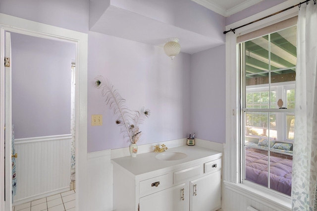 bathroom with crown molding, vanity, and tile patterned floors