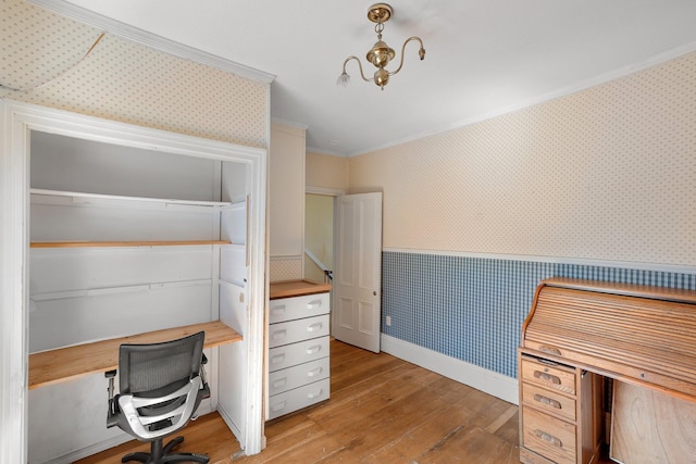 unfurnished office featuring light wood-type flooring and crown molding