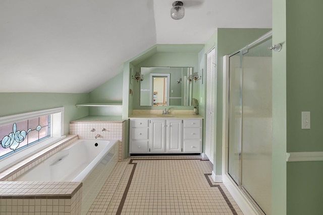 bathroom with tile patterned flooring, independent shower and bath, vanity, and vaulted ceiling