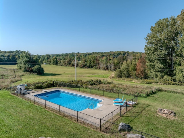 view of pool with a lawn