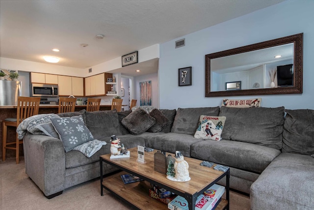 living room featuring recessed lighting, visible vents, and light colored carpet