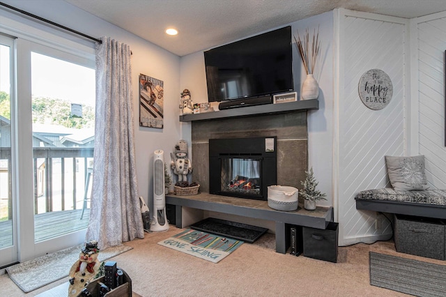 living area with recessed lighting, a multi sided fireplace, a textured ceiling, and carpet flooring