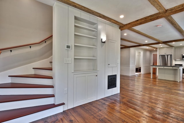 interior space with coffered ceiling, hardwood / wood-style floors, and beam ceiling