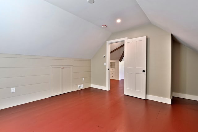 additional living space with lofted ceiling and dark hardwood / wood-style floors