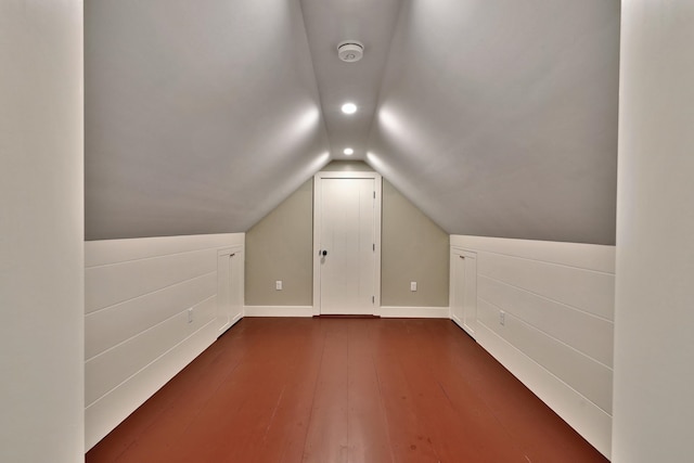 bonus room with lofted ceiling and dark hardwood / wood-style floors