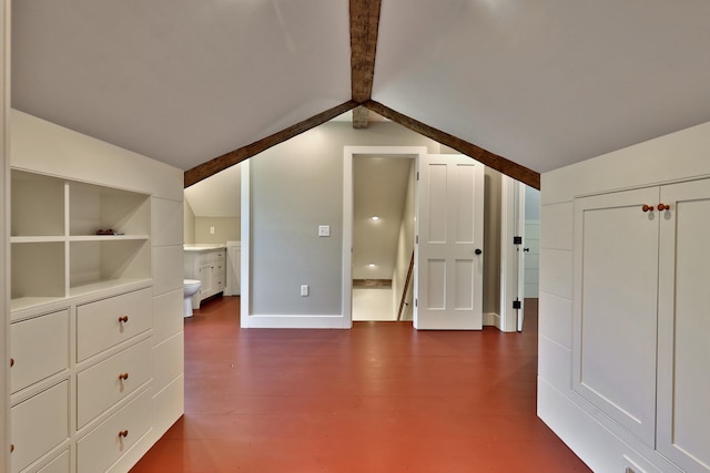 additional living space with vaulted ceiling with beams