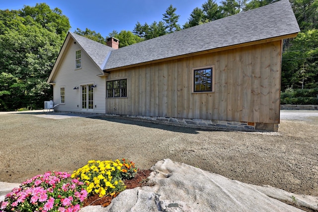 view of side of property featuring central AC and a patio area