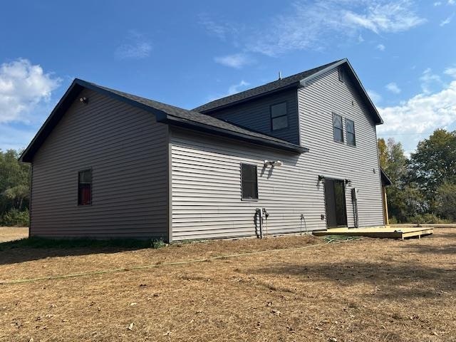 view of side of home with a lawn