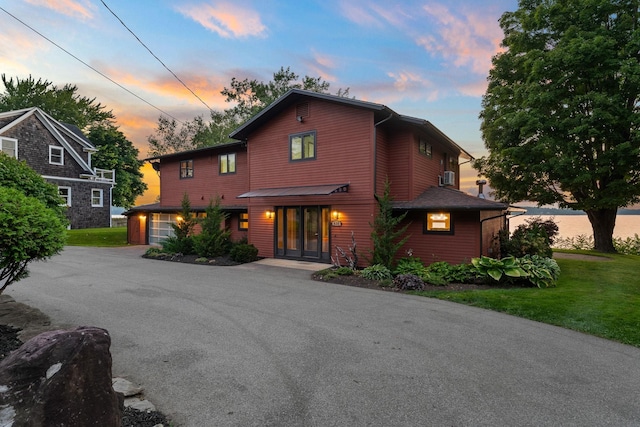 front of property featuring a garage and a yard