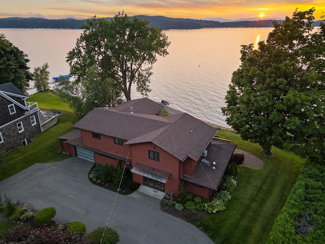 aerial view at dusk with a water view