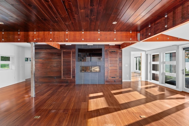 unfurnished living room with wooden ceiling, a fireplace, and hardwood / wood-style floors