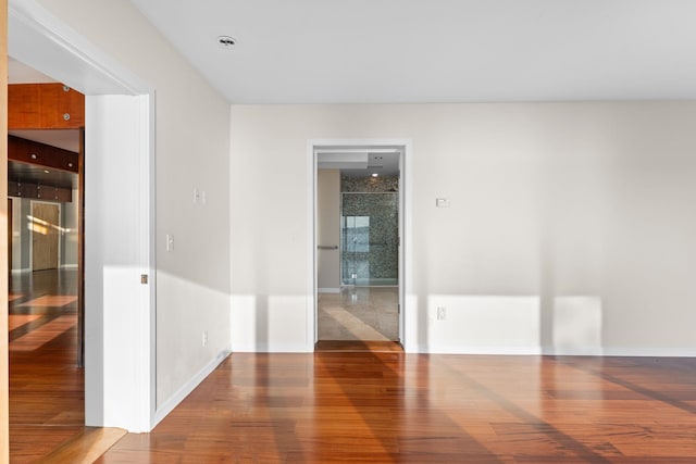 empty room with hardwood / wood-style floors