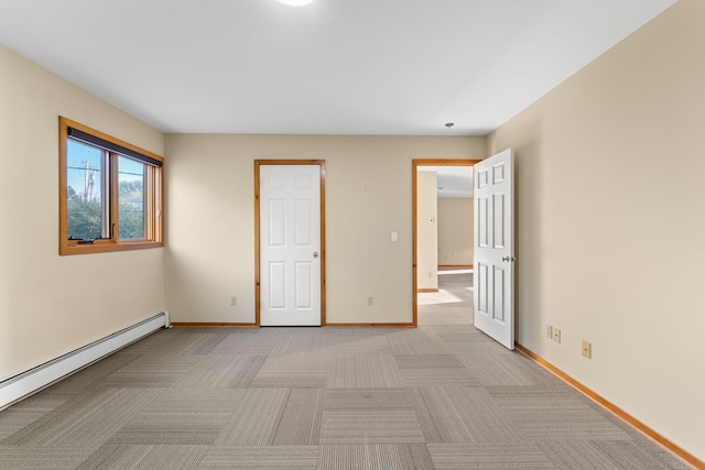 unfurnished bedroom featuring light colored carpet and a baseboard radiator