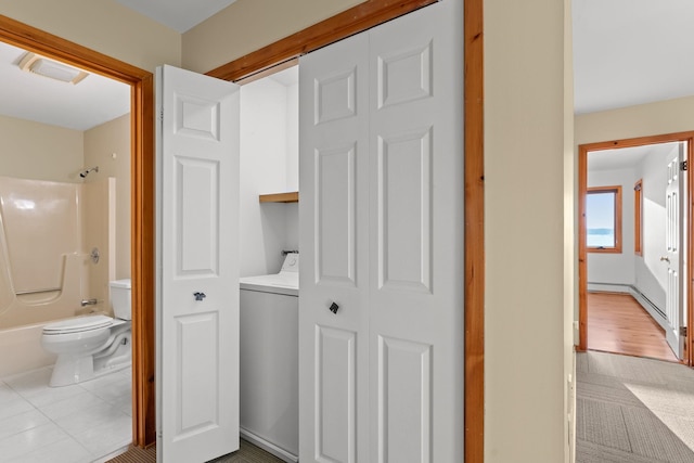 full bathroom with vanity, washer / clothes dryer, hardwood / wood-style flooring, shower / bathing tub combination, and toilet