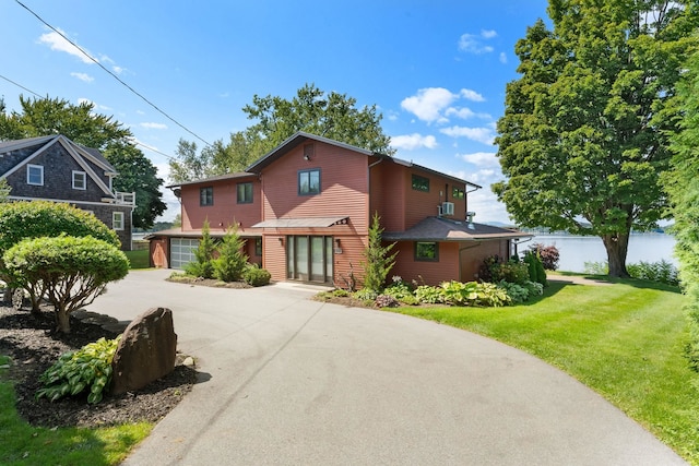 view of property with a front lawn and a garage