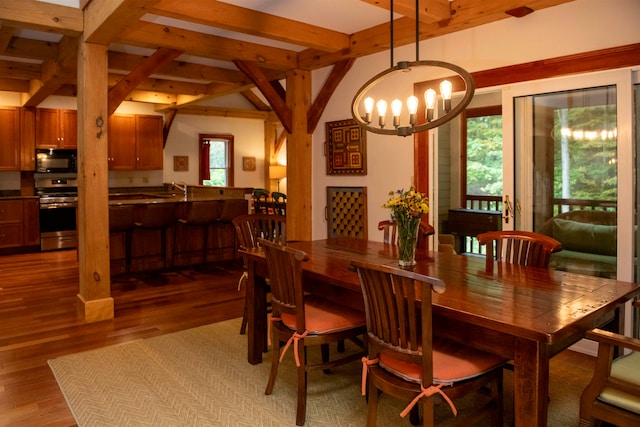 dining space with beamed ceiling, sink, light hardwood / wood-style flooring, and a chandelier