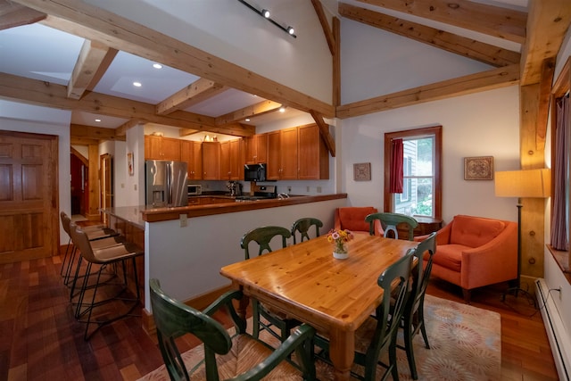 dining area with a baseboard heating unit, beamed ceiling, and hardwood / wood-style floors