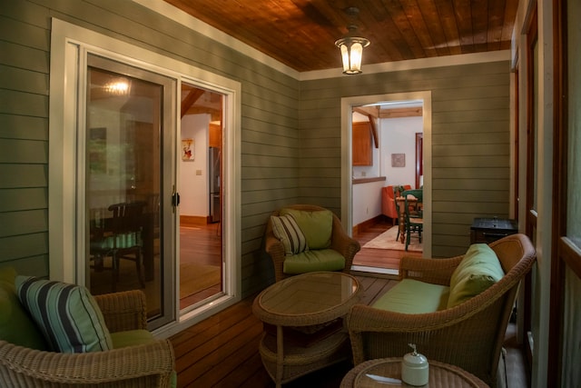 living area with wood ceiling, wood walls, and hardwood / wood-style flooring