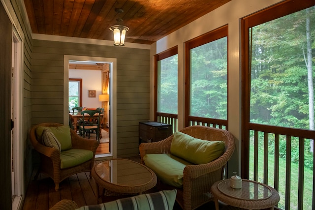 sunroom / solarium featuring wood ceiling and plenty of natural light