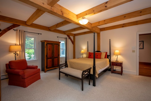 carpeted bedroom with a baseboard radiator and beam ceiling