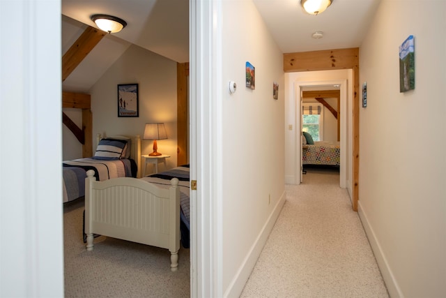 corridor featuring lofted ceiling with beams